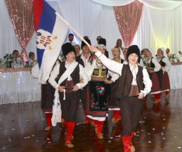 A group of young adults dancing and learning about serbian traditions and culture